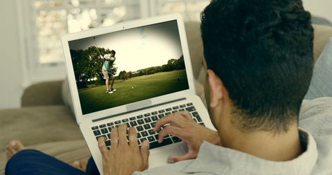 Young Man Watching Golf Tutorial on Laptop at Home - Download Free Stock Images Pikwizard.com