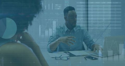 Business presenter gesturing during financial analytics review with laptop and chart overlays