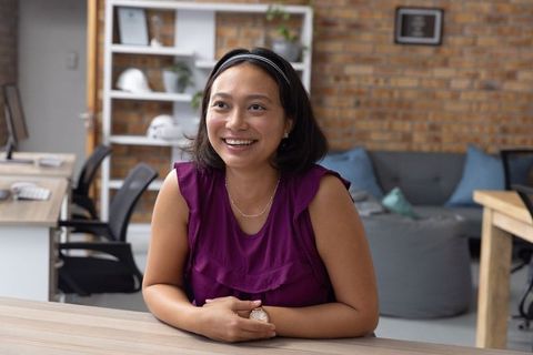 Smiling Asian Female Professional in Modern Office