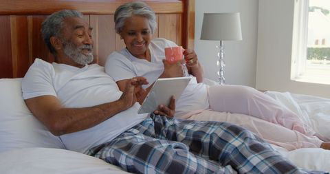 Happy Senior Couple Video Calling at Home in Bed - Download Free Stock Images Pikwizard.com