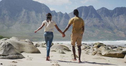 Couple Embracing Adventure During Beach Walk in Stunning Landscape
