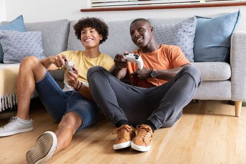 Diverse Friends Enjoying Video Gaming Together at Home
