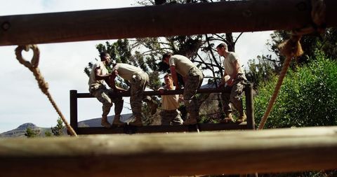 Military Team Navigating Outdoor Obstacle Course Collaboration