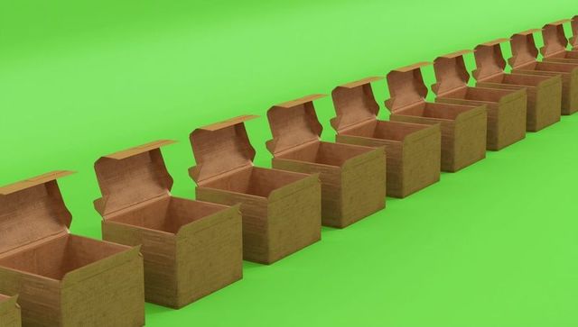 Row of Open Cardboard Boxes on Vibrant Green Background