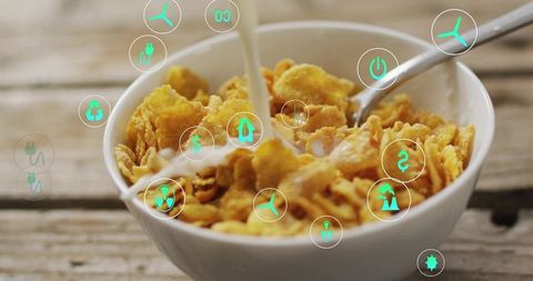 Pouring milk into cornflakes with AR sustainability icons over rustic breakfast bowl