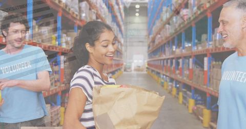 Diverse Volunteers Working in Warehouse with Donations and Productivity Analytics Overlay - Download Free Stock Images Pikwizard.com