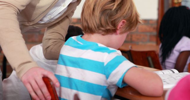 Teacher Helping Young Student with Schoolwork in Classroom - Download Free Stock Images Pikwizard.com