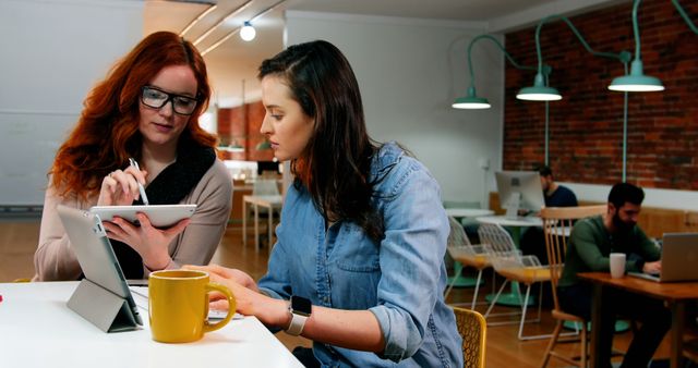 Female Colleagues Collaborating on Digital Tablet in Modern Office - Download Free Stock Images Pikwizard.com