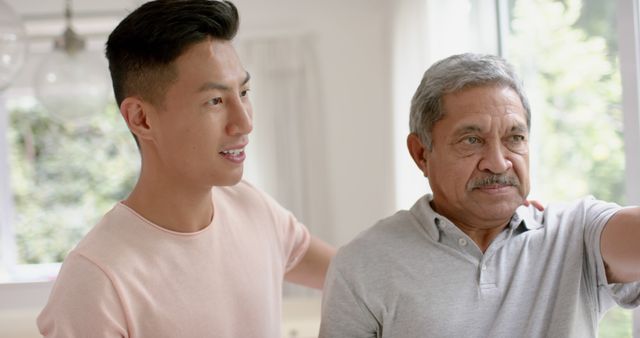 Young Man Supporting and Encouraging Elderly Father at Home - Download Free Stock Images Pikwizard.com