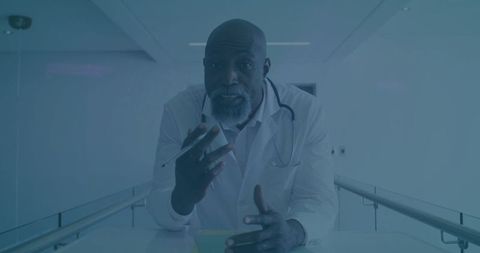 Mature Doctor Engaging Through Professional Consultation in Hospital Corridor