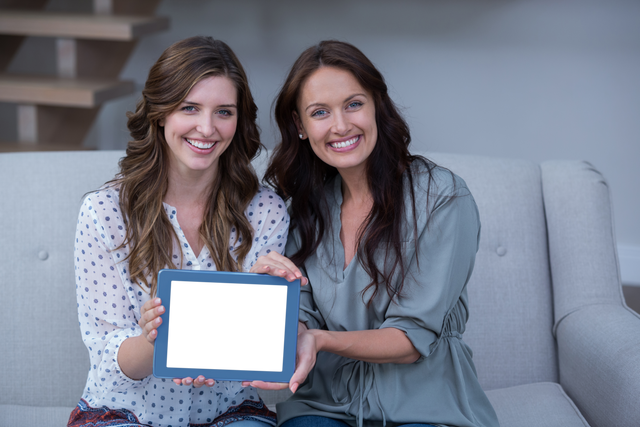 Smiling Women Holding Transparent Digital Tablet at Home - Download Free Stock Videos Pikwizard.com