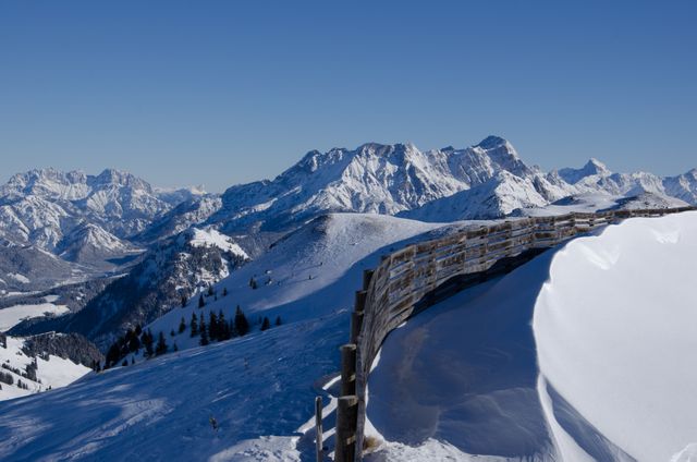 Snowy Mountain Range with Blue Sky and Wooden Fence - Download Free Stock Photos Pikwizard.com
