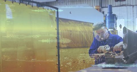 Metalworker grinding steel with angle grinder producing sparks in workshop