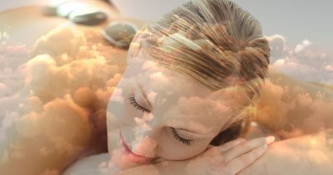 Woman Relaxing with Hot Stone Massage and Cloudscape Overlay