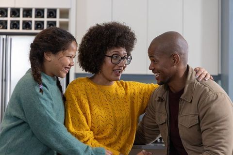 Multiracial family sharing joyful moment at modern kitchen counter