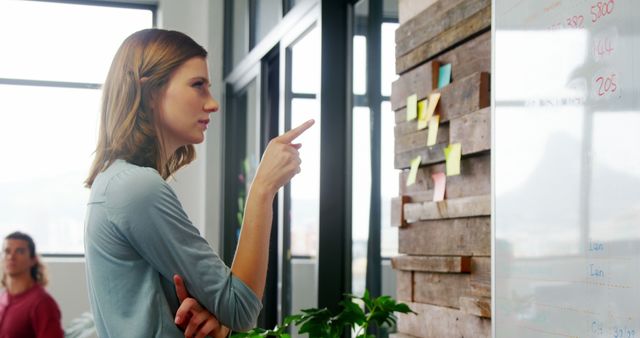 Young Professional Woman Presenting Ideas on Whiteboard in Modern Office - Download Free Stock Images Pikwizard.com