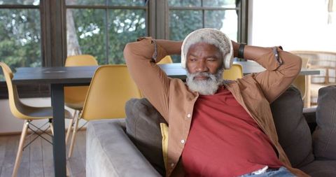 African American Man Relaxing at Home with Headphones