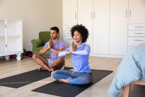 Diverse Couple Meditating Together Indoors for Mindfulness