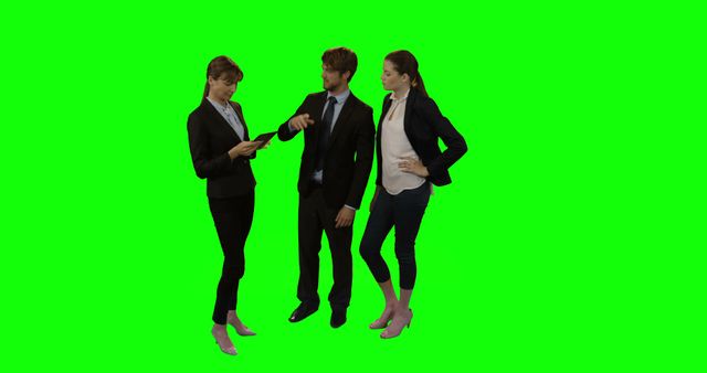 Group of business professionals in office attire are collaborating. Suitable for corporate, business, and teamwork concepts. Perfect for projects requiring green screen backgrounds to customize surroundings.
