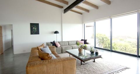 Contemporary living room with large windows and cozy sofas