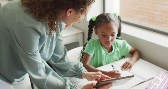 Teacher Instructing Young Student with Tablet in Classroom - Download Free Stock Images Pikwizard.com