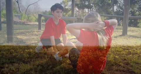 Children Enjoying Outdoor Fitness with Sit-Ups in Sunny Park