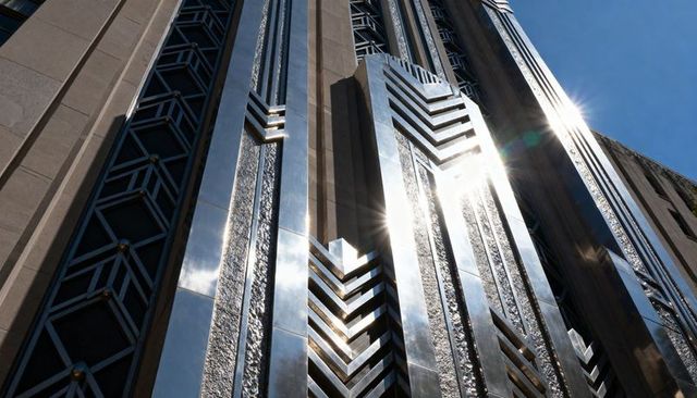 Gleaming art deco facade with chevron chrome panels and geometric lattice details