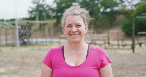 Smiling Woman in Pink T-Shirt at Outdoor Boot Camp - Download Free Stock Images Pikwizard.com