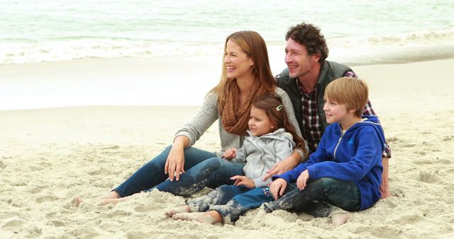 Family enjoying a day at the beach, sitting on the sand, and smiling together. The scenario appears warm and light-hearted, showcasing parental bonding with children. Use for vacation planning, travel brochures, family activities advertisements, and lifestyle articles.