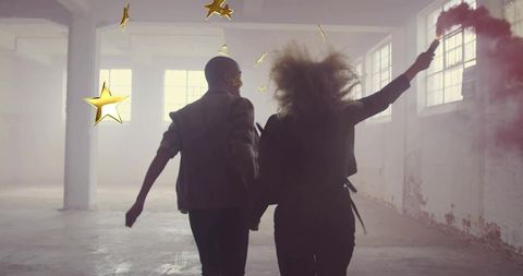 Couple Running with Smoke Flare in Industrial Loft with Gold Stars