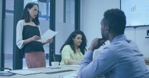 Businesswoman Presenting in Modern Meeting Room with Team