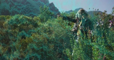 Adventurous Couple Hiking Amidst Scenic Mountain Wildflowers
