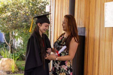 Proud Mother and Graduate Daughter Celebrating Achievement Outdoors