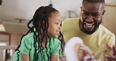 Father and daughter engaging in fun science experiment