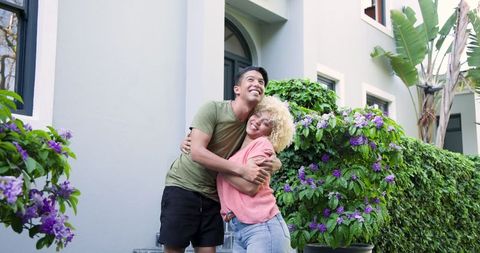 Couple Moving into New Home Embracing by Front Door