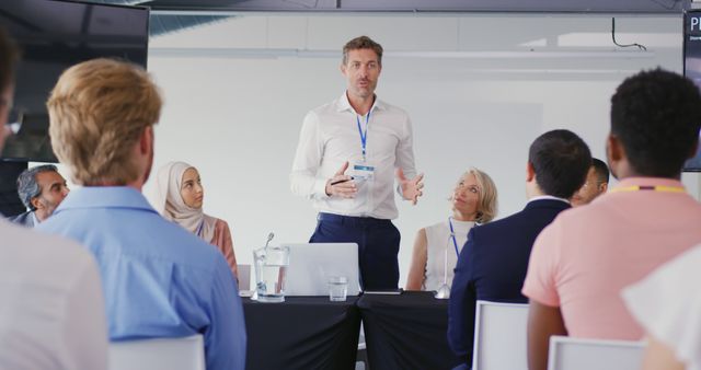 Diverse Business Team in Meeting With Male Leader Presenting Idea - Download Free Stock Images Pikwizard.com