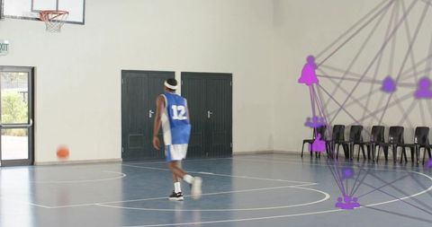 Male basketball player walking across indoor court with motion overlay and rolling ball