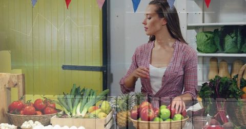 Young Woman Selling Apples at Rustic Farmers Market Stall with Fresh Produce and Baskets