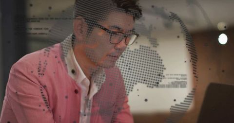 Asian Professional Analyzing Data Overlay on Laptop in Modern Office