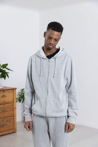 Contemplative Man in Minimalist Home Interior Wearing Sportswear