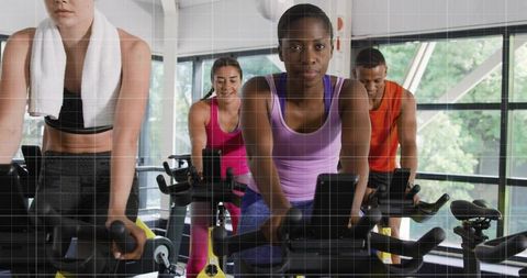 Focused Group Spin Class Cycling with Determined Enthusiasm