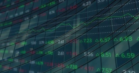 Financial stock market data reflected on glass building