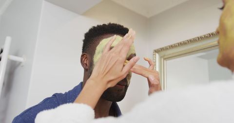 Happy Couple Applying Face Mask in Bathroom - Download Free Stock Images Pikwizard.com