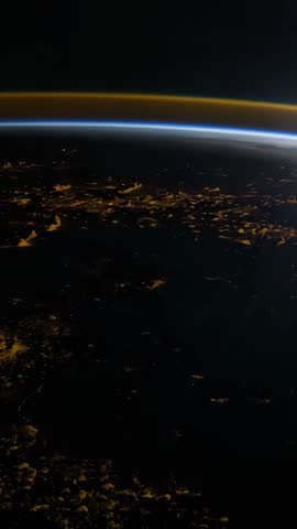 Orbiting Earth Twilight Transition into Night with Emerging City Lights Vertical Video