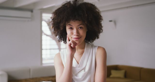 Confident Young Woman Smiling Indoors with Hand on Chin - Download Free Stock Images Pikwizard.com