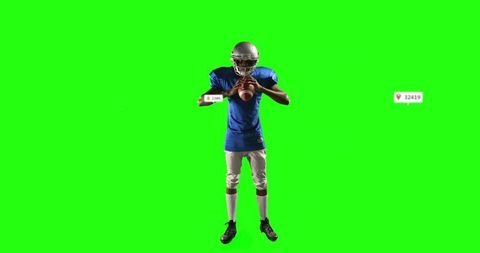 Football player wearing helmet holding football on green screen with digital overlays