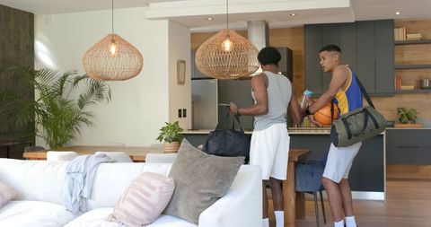 Friends Preparing for Basketball Session in Modern Kitchen