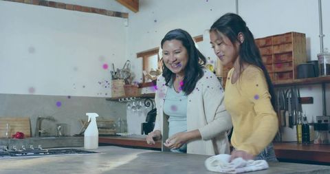 Mother and Daughter Cleaning Kitchen Countertop Smiling Family Bonding Rustic Home