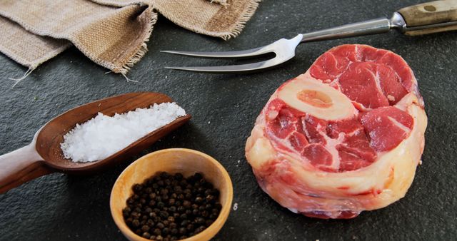 Raw Beef Osso Buco with Seasoning and Carving Fork on Black Background - Download Free Stock Images Pikwizard.com