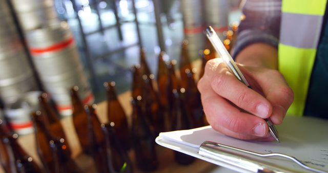 Worker Taking Inventory in Brewery, Counting Glass Bottles - Download Free Stock Images Pikwizard.com